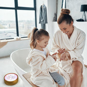 mother and daughter treating dry skin with non toxic beef tallow baby momma cream