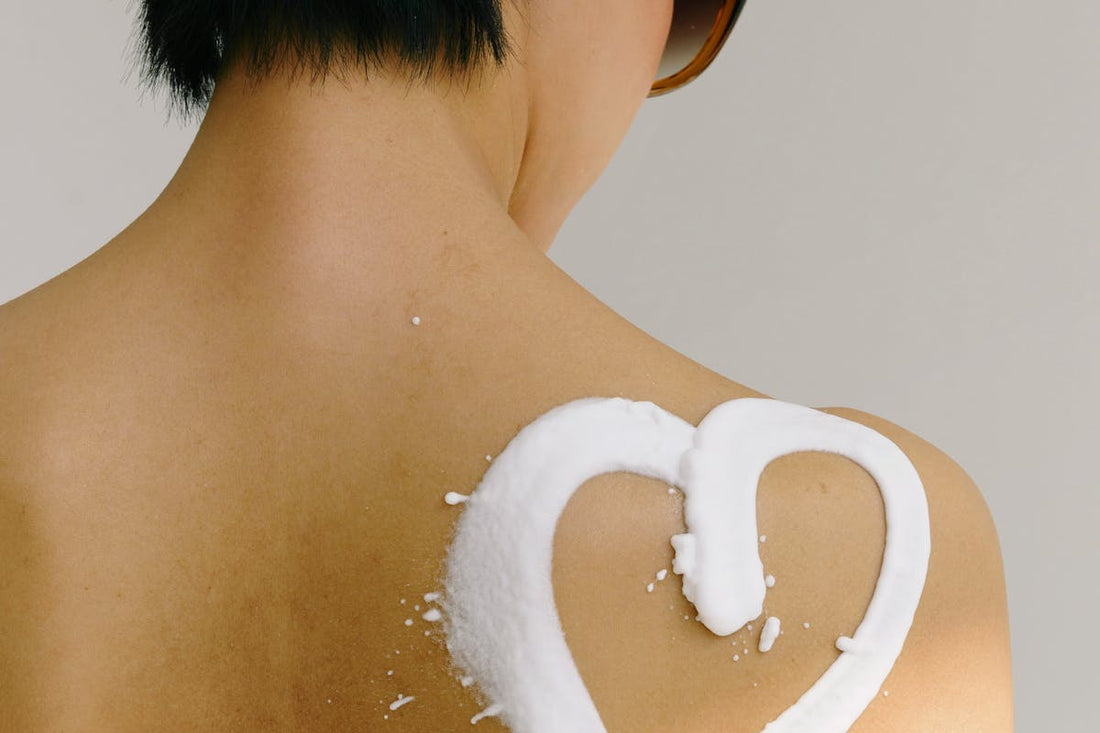 Woman with heart-shaped sunscreen on shoulder - non-nano zinc oxide sun protection