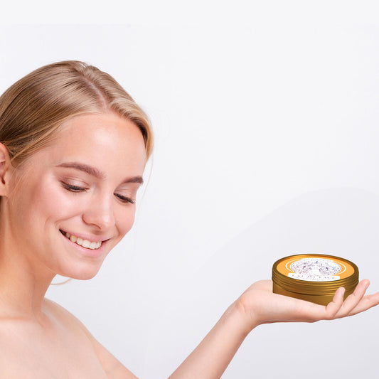 Hand holding a tin of grass-fed beef tallow balm — a lipid-rich balm outlasts water-based hand lotion on dry cracked hands