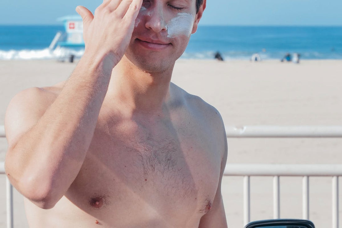 Man applying mineral sunscreen at beach - zinc oxide vs chemical sunscreen comparison