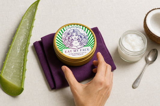 Aloe vera leaf, jar of beef tallow balm, and a coconut split open arranged on a beach towel