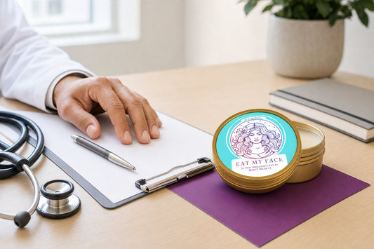 Open Eat My Face Original tallow tin on a dermatologist's desk beside a stethoscope and clipboard