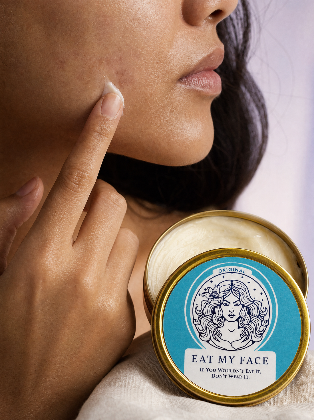 Closeup of woman applying Eat My Face Original Tallow Moisturizer with fingertip to faint facial scar marks