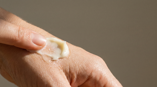Close-up of thick tallow cream pressed into the back of a hand, how to pick a good jar of tallow lotion