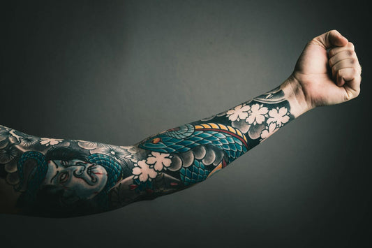 Colorful sleeve tattoo with floral design on arm — tattoo aftercare with beef tallow moisturizer