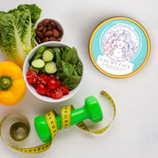 Alt Tag: Beef Tallow Moisturizer - Original Eat My Face tallow hydration cream tin flat lay with fresh veggies, almonds, dumbbell and tape