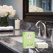 Natural Tallow Bar Soap – Minty mint and rosemary tallow soap bar on bathroom sink counter with faucet, candle, and towel