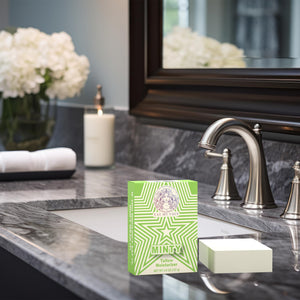 Natural Tallow Bar Soap – Minty mint and rosemary tallow soap bar on bathroom sink counter with faucet, candle, and towel